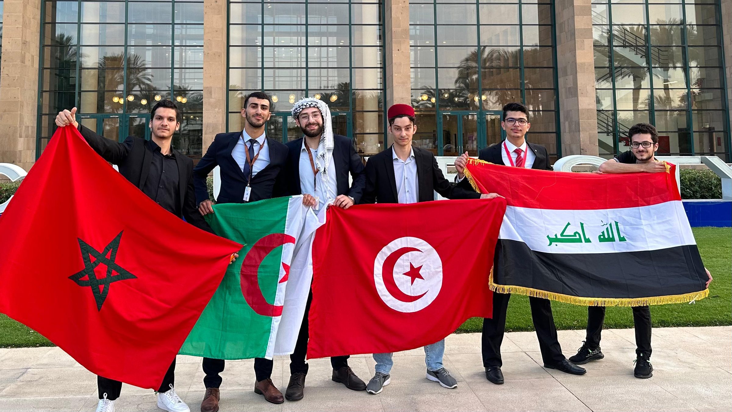 Scholars holding the flags of their countries