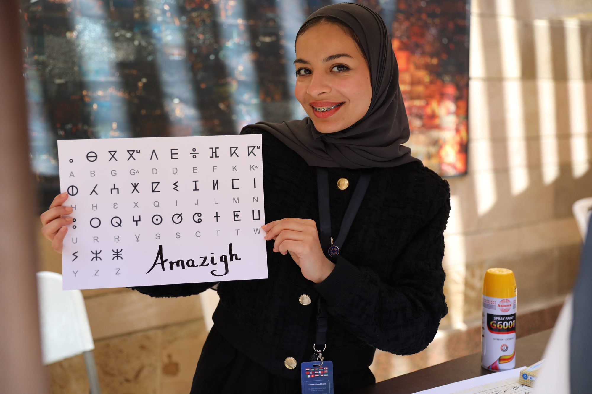 A student presenting the Amazigh alphabet at the exhibition