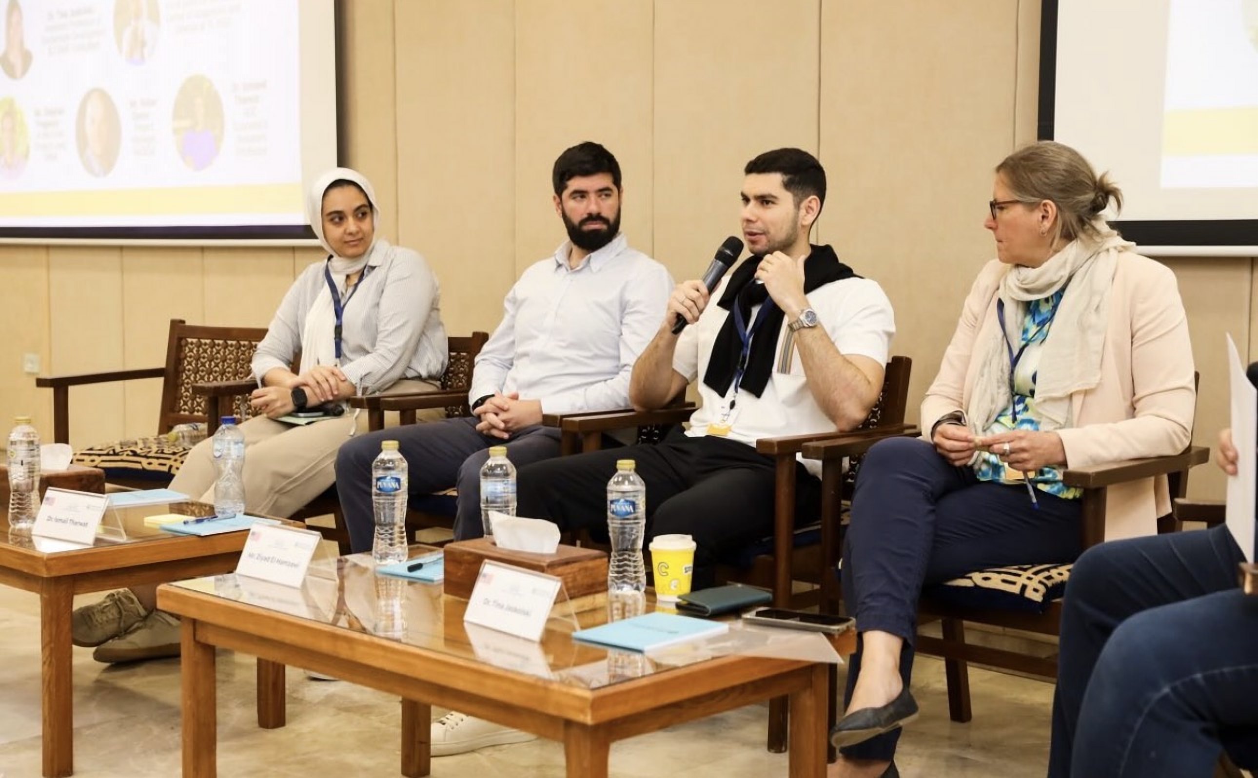 Four panellists in discussion during a session