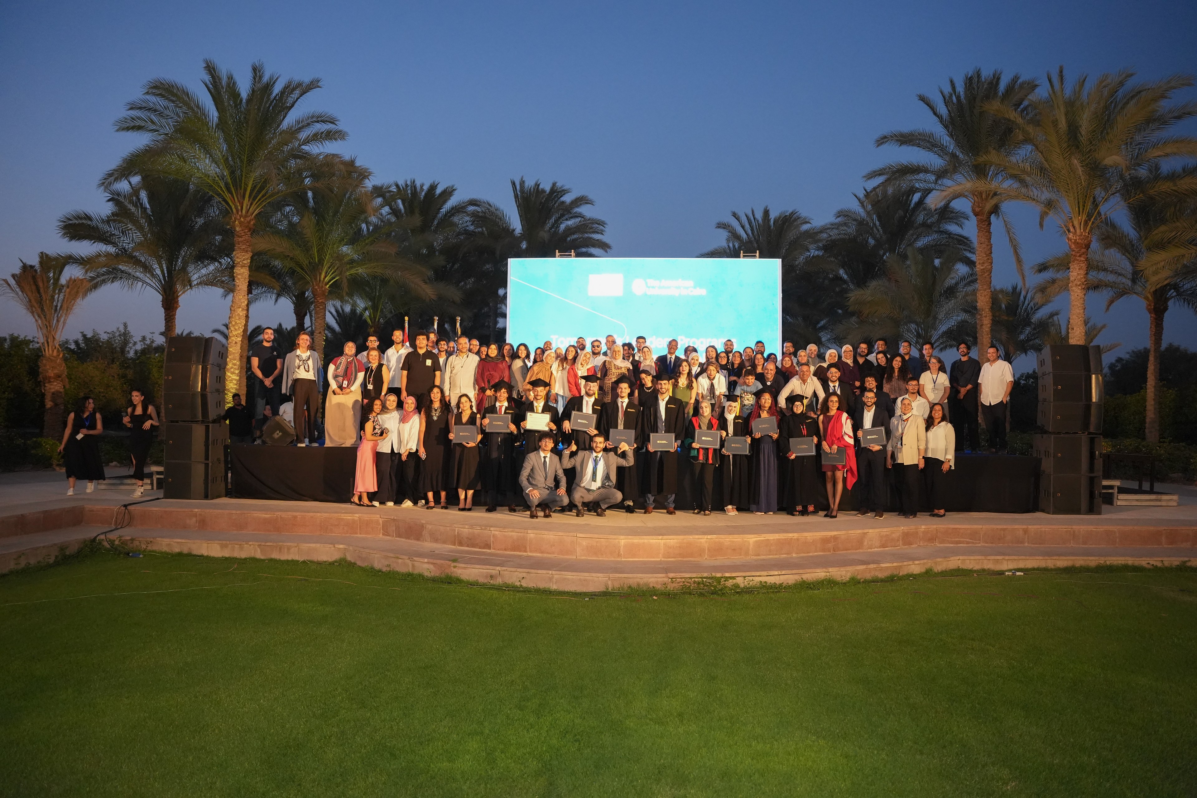Tomorrow's Leaders scholars and staff gathered on stage at the graduation ceremony