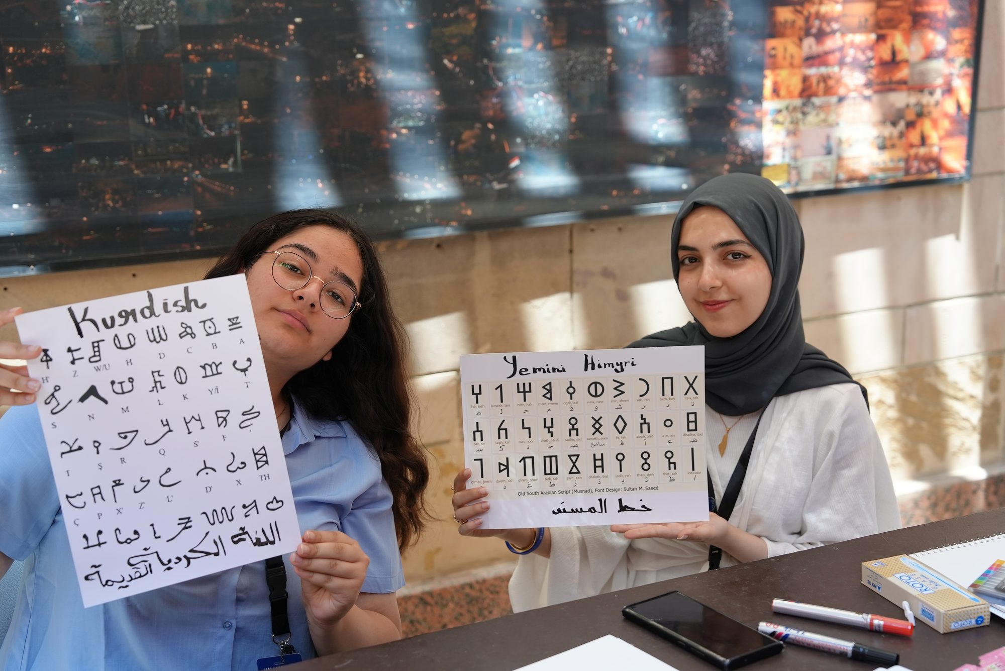 Scholars presenting the scripts of the region at a cultural fair