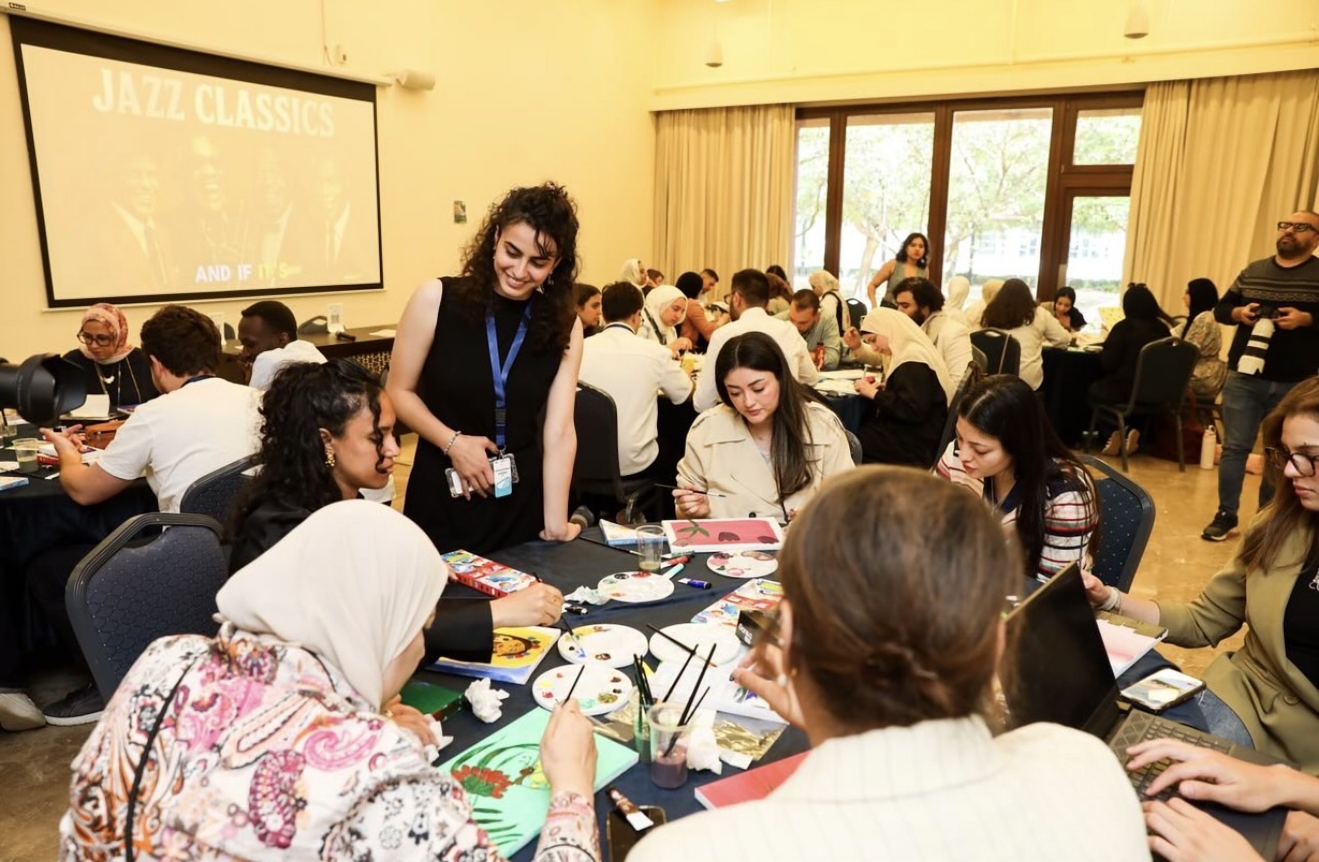 Scholars painting during a creative workshop